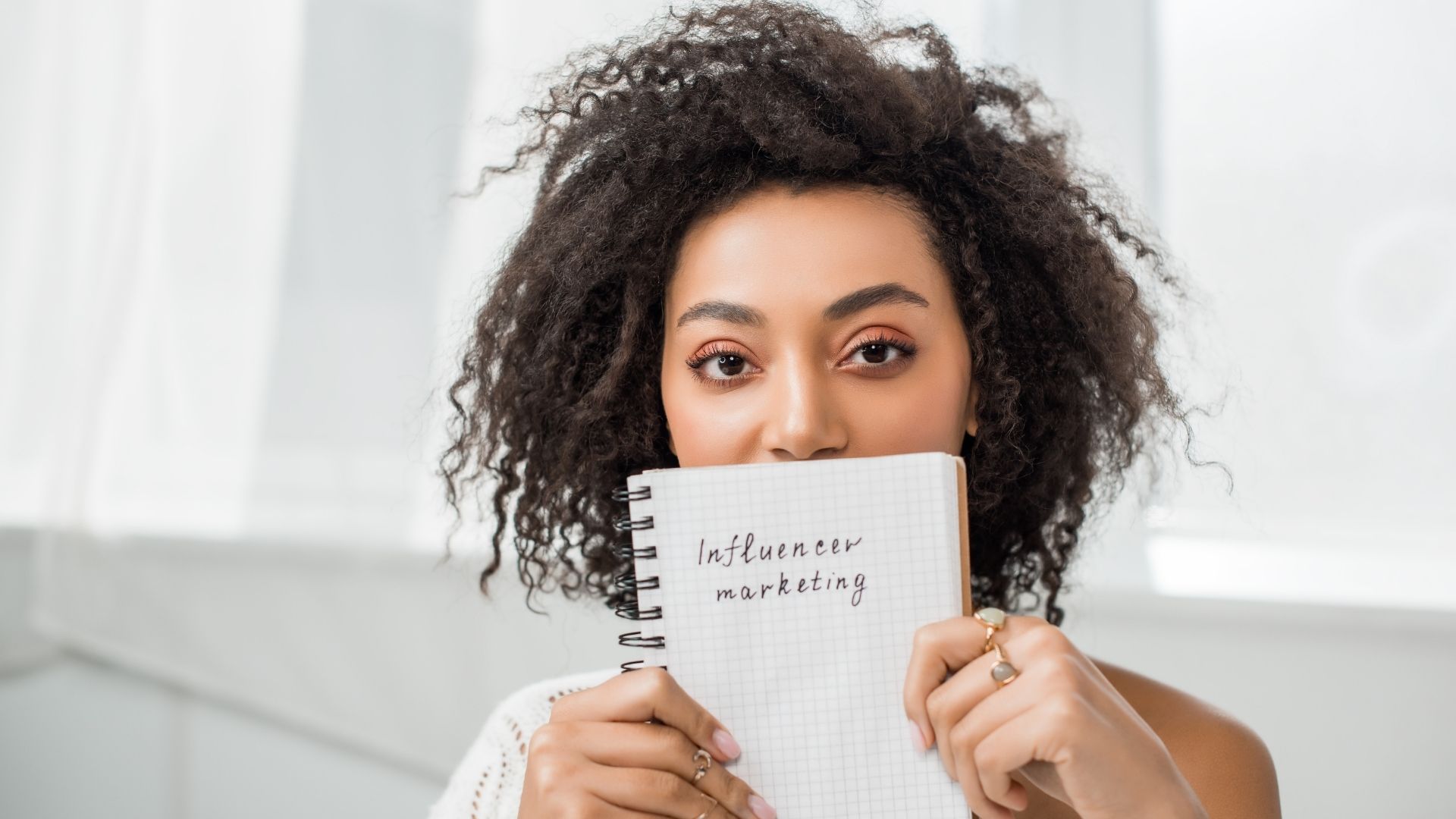 Woman holding paper with influencer marketing
